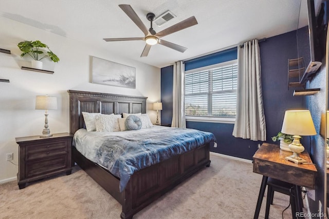 bedroom featuring a ceiling fan, light colored carpet, and baseboards