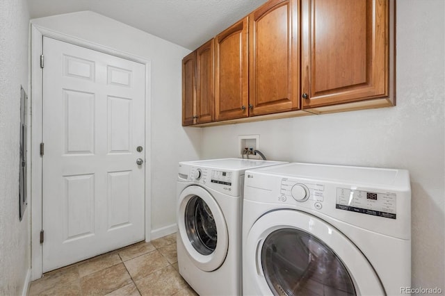 laundry area with washer and dryer, cabinet space, and light tile patterned floors