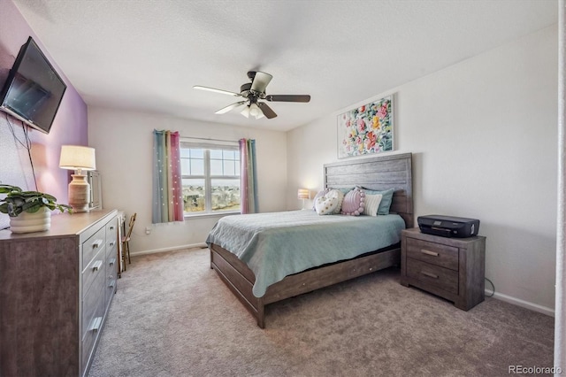 bedroom featuring light colored carpet, a ceiling fan, and baseboards