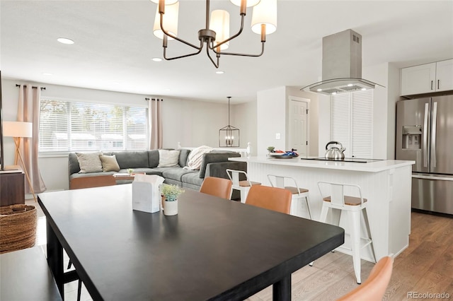 6163 W 76th Ave, Arvada, CO 80003 - dining area featuring a chandelier, light wood-style floors, and recessed lighting