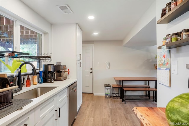 6163 W 76th Ave, Arvada, CO 80003 - kitchen with stainless steel dishwasher, light wood-type flooring, white cabinetry, open shelves, and recessed lighting