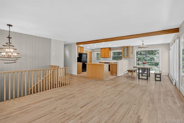 11701 Spruce Canyon Cir, Golden, CO 80403 - kitchen featuring a chandelier, baseboard heating, freestanding refrigerator, and a center island