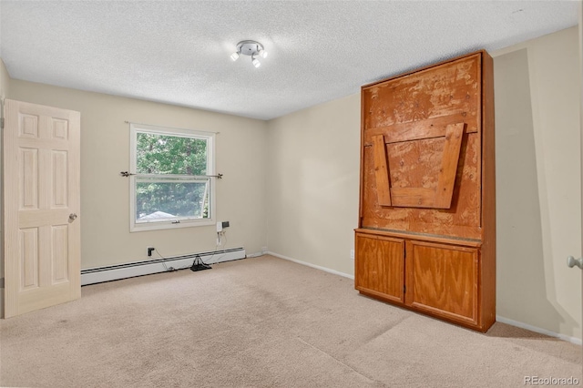 11701 Spruce Canyon Cir, Golden, CO 80403 - spare room featuring a baseboard heating unit, light colored carpet, and a textured ceiling