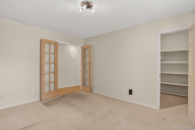 11701 Spruce Canyon Cir, Golden, CO 80403 - unfurnished bedroom with carpet flooring, a textured ceiling, and a spacious closet