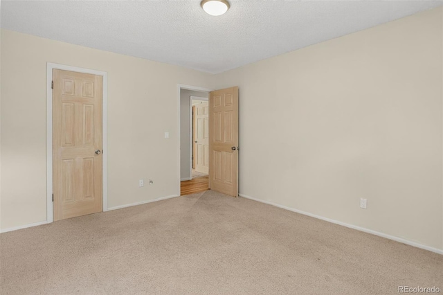 11701 Spruce Canyon Cir, Golden, CO 80403 - carpeted spare room featuring baseboards and a textured ceiling