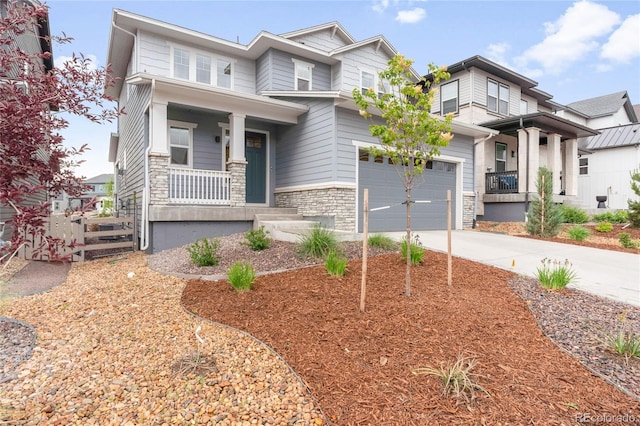 8582 Cheraw St, Littleton, CO 80125 - view of front of home with covered porch, concrete driveway, and stone siding