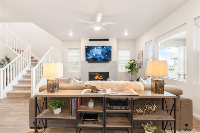8582 Cheraw St, Littleton, CO 80125 - living room with stairway, ceiling fan, wood finished floors, and a glass covered fireplace
