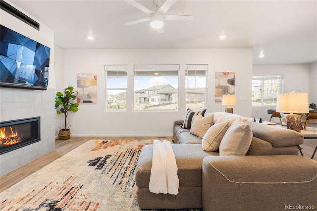 8582 Cheraw St, Littleton, CO 80125 - living area featuring wood finished floors, a tile fireplace, recessed lighting, and ceiling fan