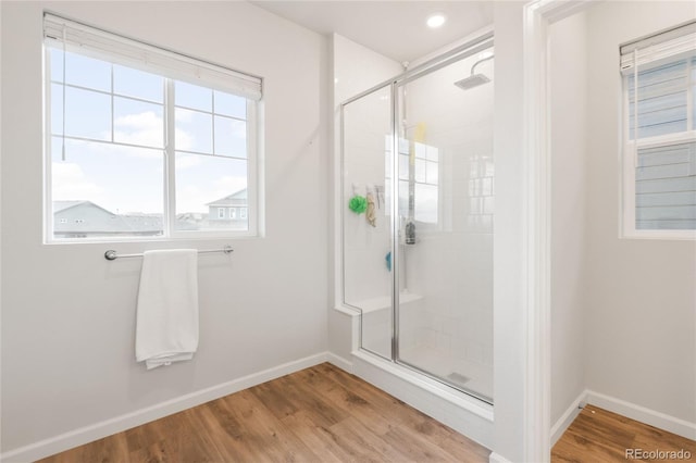 8582 Cheraw St, Littleton, CO 80125 - bathroom with a stall shower and wood finished floors