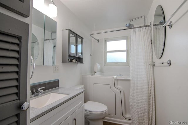 5211 Dover St, Arvada, CO 80002 - full bathroom featuring toilet, vanity, and shower / bath combo