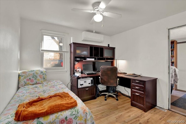 5211 Dover St, Arvada, CO 80002 - bedroom featuring an AC wall unit, a desk, light wood-style flooring, and a ceiling fan