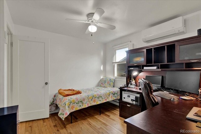 5211 Dover St, Arvada, CO 80002 - bedroom with a wall mounted AC, light wood-style floors, an office area, and a ceiling fan