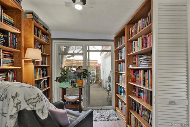 5211 Dover St, Arvada, CO 80002 - sitting room featuring wall of books, ceiling fan, and wood finished floors