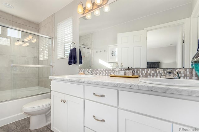 full bathroom with tasteful backsplash, vanity, hardwood / wood-style flooring, enclosed tub / shower combo, and toilet