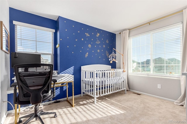 carpeted bedroom with a crib