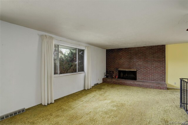 1720 S Balsam St, Lakewood, CO 80232 - unfurnished living room with visible vents, carpet, and a brick fireplace