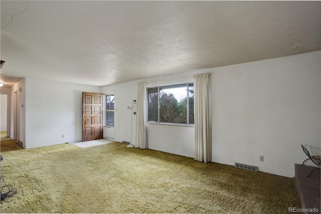 1720 S Balsam St, Lakewood, CO 80232 - unfurnished living room featuring visible vents and carpet flooring