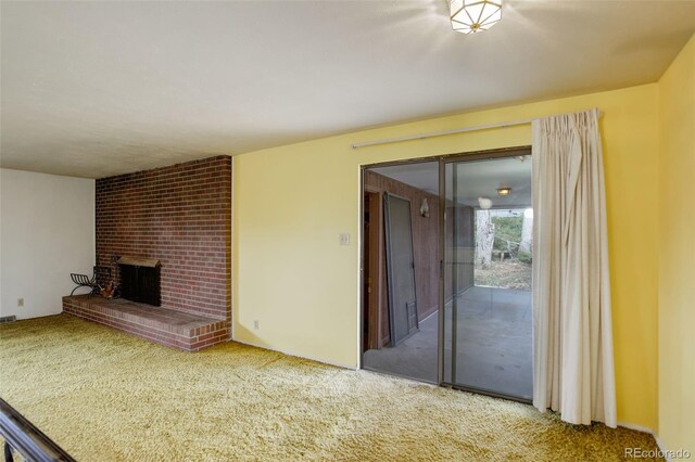 1720 S Balsam St, Lakewood, CO 80232 - unfurnished living room featuring carpet floors and a brick fireplace