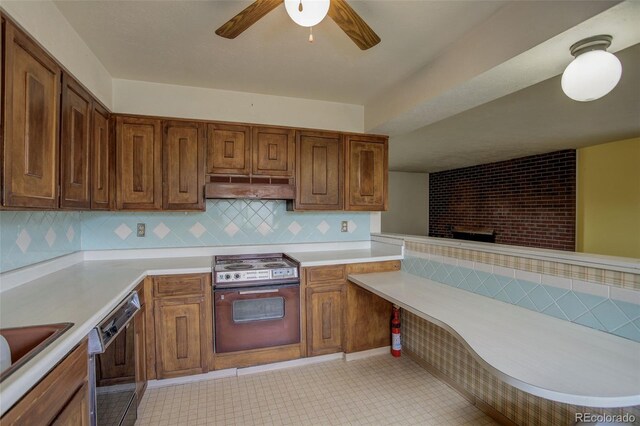 1720 S Balsam St, Lakewood, CO 80232 - kitchen with a ceiling fan, under cabinet range hood, dishwasher, light countertops, and oven