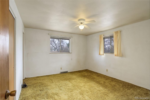 1720 S Balsam St, Lakewood, CO 80232 - carpeted spare room with visible vents, a wealth of natural light, and a ceiling fan