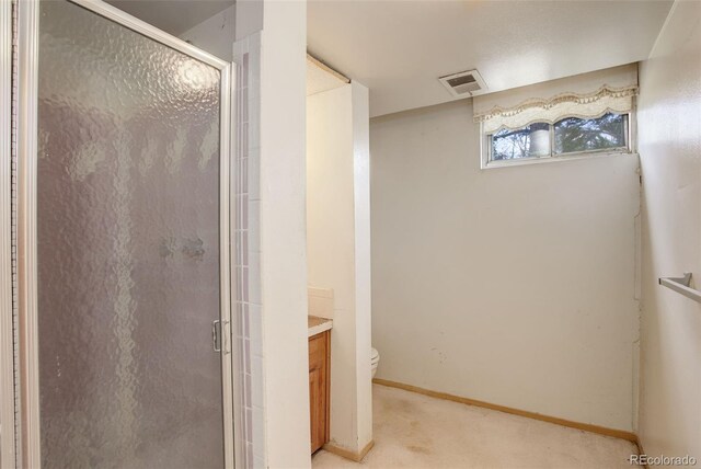 1720 S Balsam St, Lakewood, CO 80232 - bathroom featuring visible vents, baseboards, toilet, vanity, and a stall shower