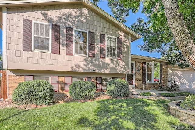4664 S Zang St, Morrison, CO 80465 - split level home with brick siding, a front lawn, and a garage