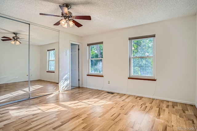 4664 S Zang St, Morrison, CO 80465 - unfurnished bedroom featuring a textured ceiling, wood finished floors, a closet, and ceiling fan