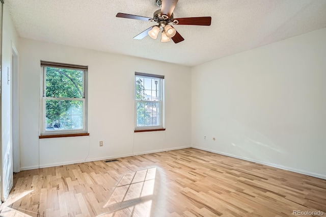4664 S Zang St, Morrison, CO 80465 - spare room featuring wood finished floors, healthy amount of natural light, a textured ceiling, and ceiling fan