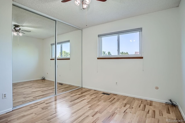 4664 S Zang St, Morrison, CO 80465 - unfurnished bedroom with a textured ceiling, wood finished floors, a closet, and ceiling fan