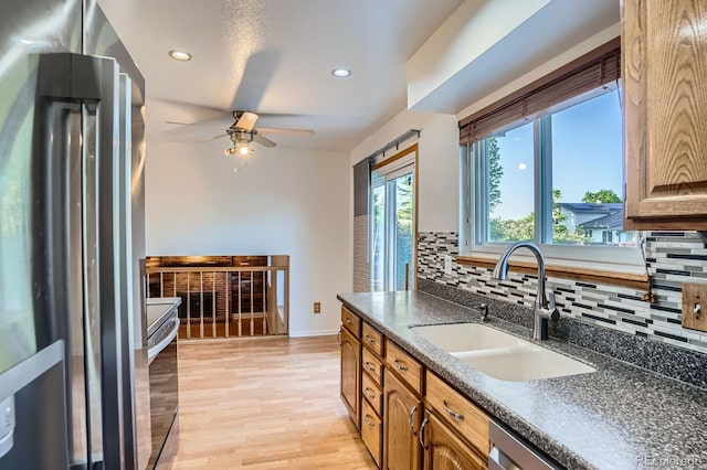 4664 S Zang St, Morrison, CO 80465 - kitchen with appliances with stainless steel finishes, decorative backsplash, ceiling fan, recessed lighting, and light wood-style flooring