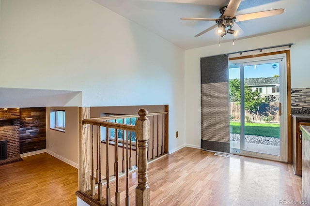 4664 S Zang St, Morrison, CO 80465 - doorway to outside featuring wood finished floors, plenty of natural light, ceiling fan, and a fireplace