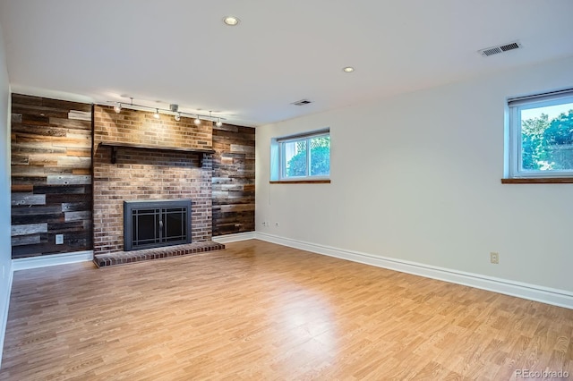 4664 S Zang St, Morrison, CO 80465 - unfurnished living room featuring track lighting, wood finished floors, a fireplace, and recessed lighting