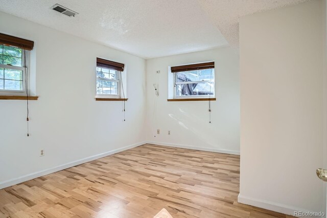 4664 S Zang St, Morrison, CO 80465 - spare room with light wood finished floors and a textured ceiling