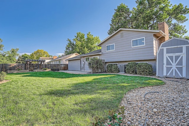 4664 S Zang St, Morrison, CO 80465 - back of property featuring a storage unit, a chimney, and a fenced backyard