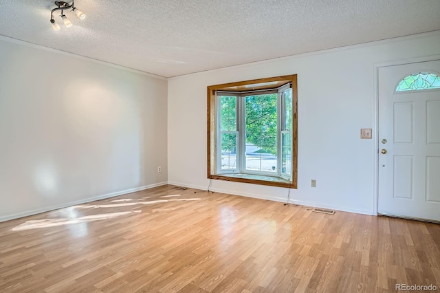 4664 S Zang St, Morrison, CO 80465 - spare room with light wood finished floors, a textured ceiling, and ornamental molding