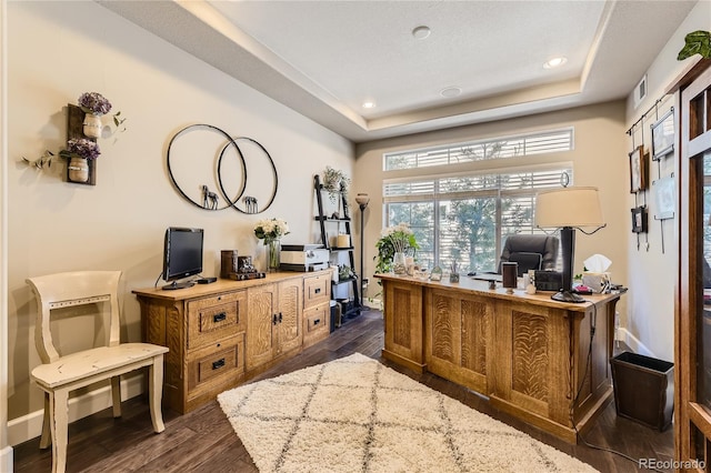 office with a tray ceiling and dark hardwood / wood-style flooring