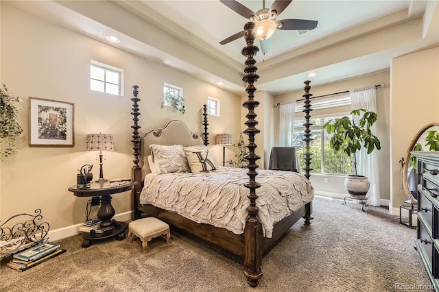 bedroom with ceiling fan, multiple windows, and carpet floors