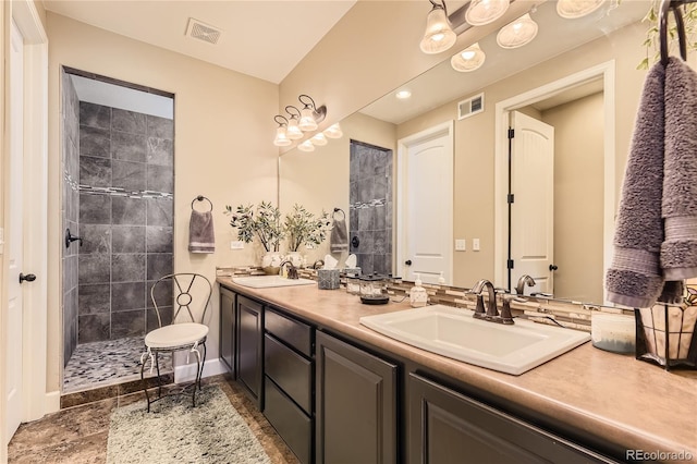 bathroom with vanity and a tile shower