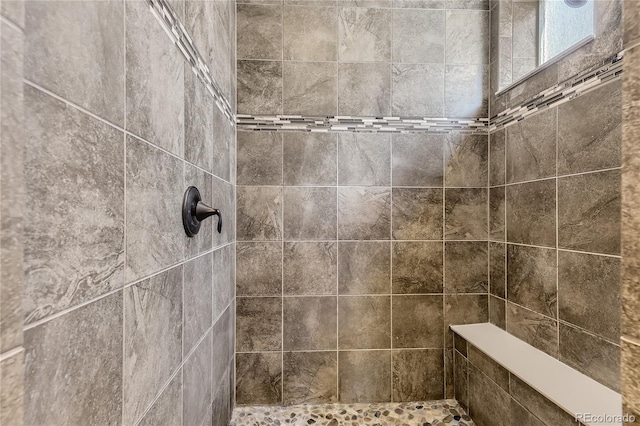 bathroom with tiled shower