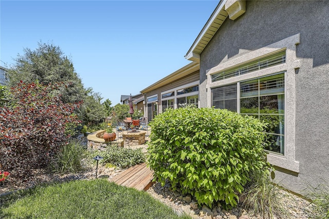 view of home's exterior with an outdoor fire pit