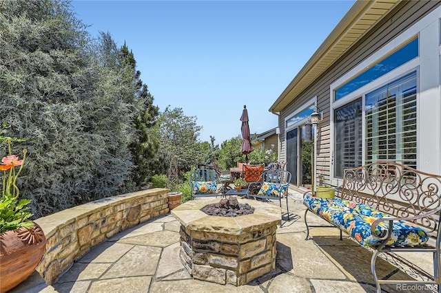 view of patio / terrace featuring an outdoor fire pit