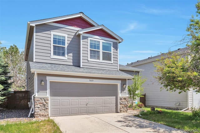 9889 Aftonwood St, Highlands Ranch, CO 80126 - view of front of house featuring stone siding, an attached garage, driveway, and fence
