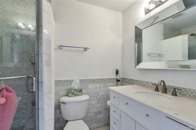 9889 Aftonwood St, Highlands Ranch, CO 80126 - full bathroom featuring a shower stall, toilet, a wainscoted wall, vanity, and tile walls