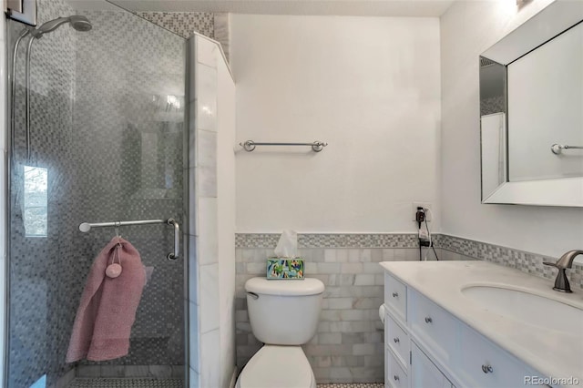 9889 Aftonwood St, Highlands Ranch, CO 80126 - bathroom featuring a stall shower, vanity, toilet, a wainscoted wall, and tile walls