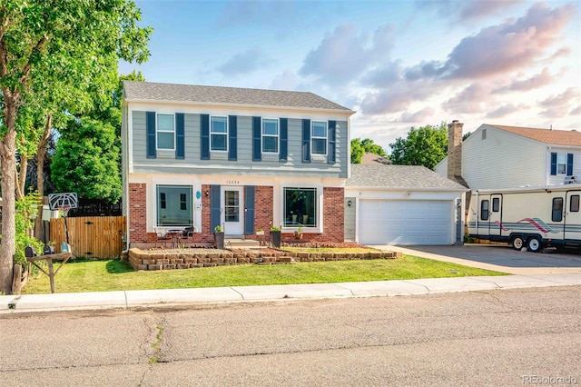 12234 W Saratoga Ave, Morrison, CO 80465 - view of front of home with driveway, brick siding, and a garage