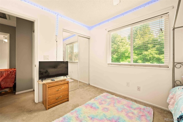 12234 W Saratoga Ave, Morrison, CO 80465 - bedroom featuring light colored carpet, a textured ceiling, and a closet