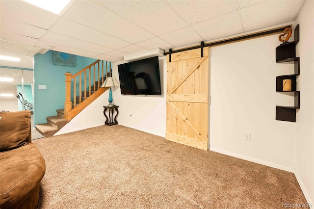 12234 W Saratoga Ave, Morrison, CO 80465 - unfurnished living room with carpet, stairs, a paneled ceiling, and a barn door