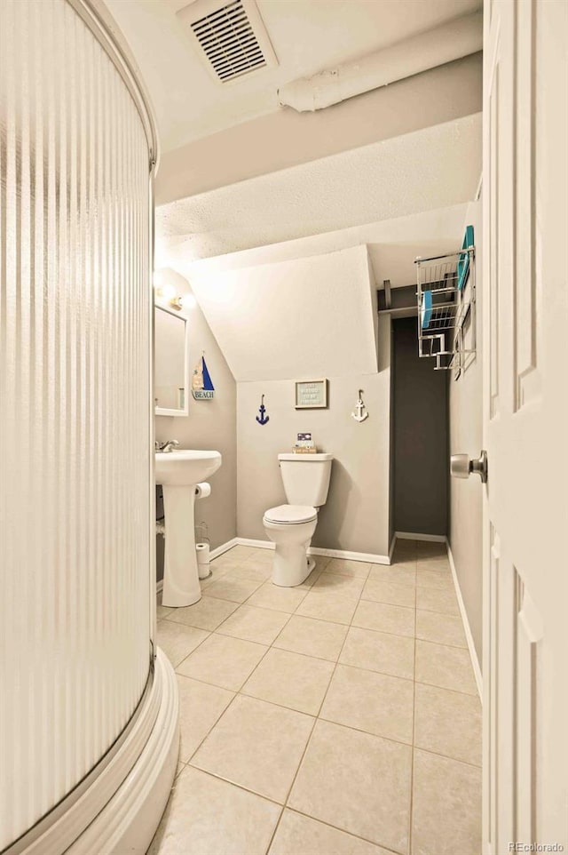 12234 W Saratoga Ave, Morrison, CO 80465 - bathroom featuring tile patterned flooring and lofted ceiling