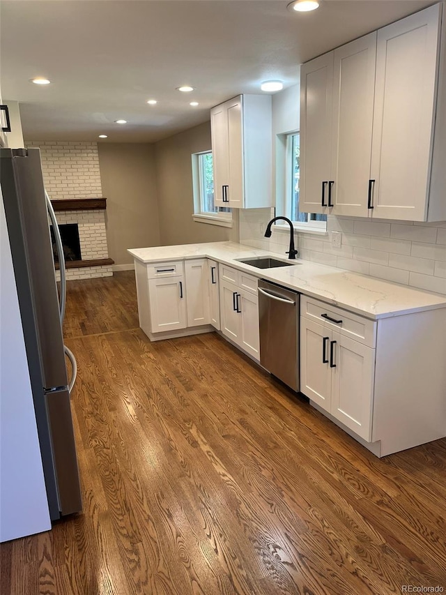 2836 S Fenton St, Denver, CO 80227 - kitchen featuring stainless steel appliances, white cabinetry, light stone countertops, dark wood-style floors, and recessed lighting