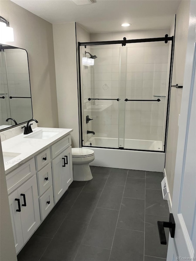 2836 S Fenton St, Denver, CO 80227 - full bathroom featuring shower / bath combination with glass door, double vanity, tile patterned floors, and recessed lighting